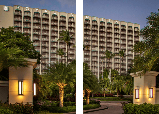 hotel building featuring a prominent large sign at the entrance, clearly visible against the surrounding landscape.