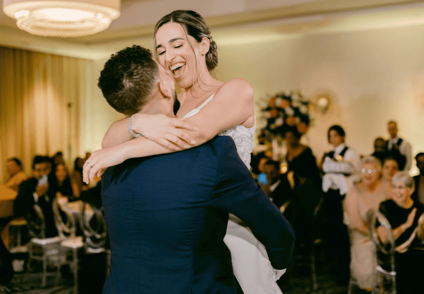 A beautifully arranged wedding reception showcasing decorated tables and a festive atmosphere.