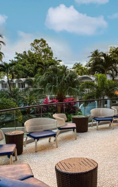 A scenic view of the pool area at the Marriott Resort in Miami, featuring lounge chairs and palm trees under a clear sky.