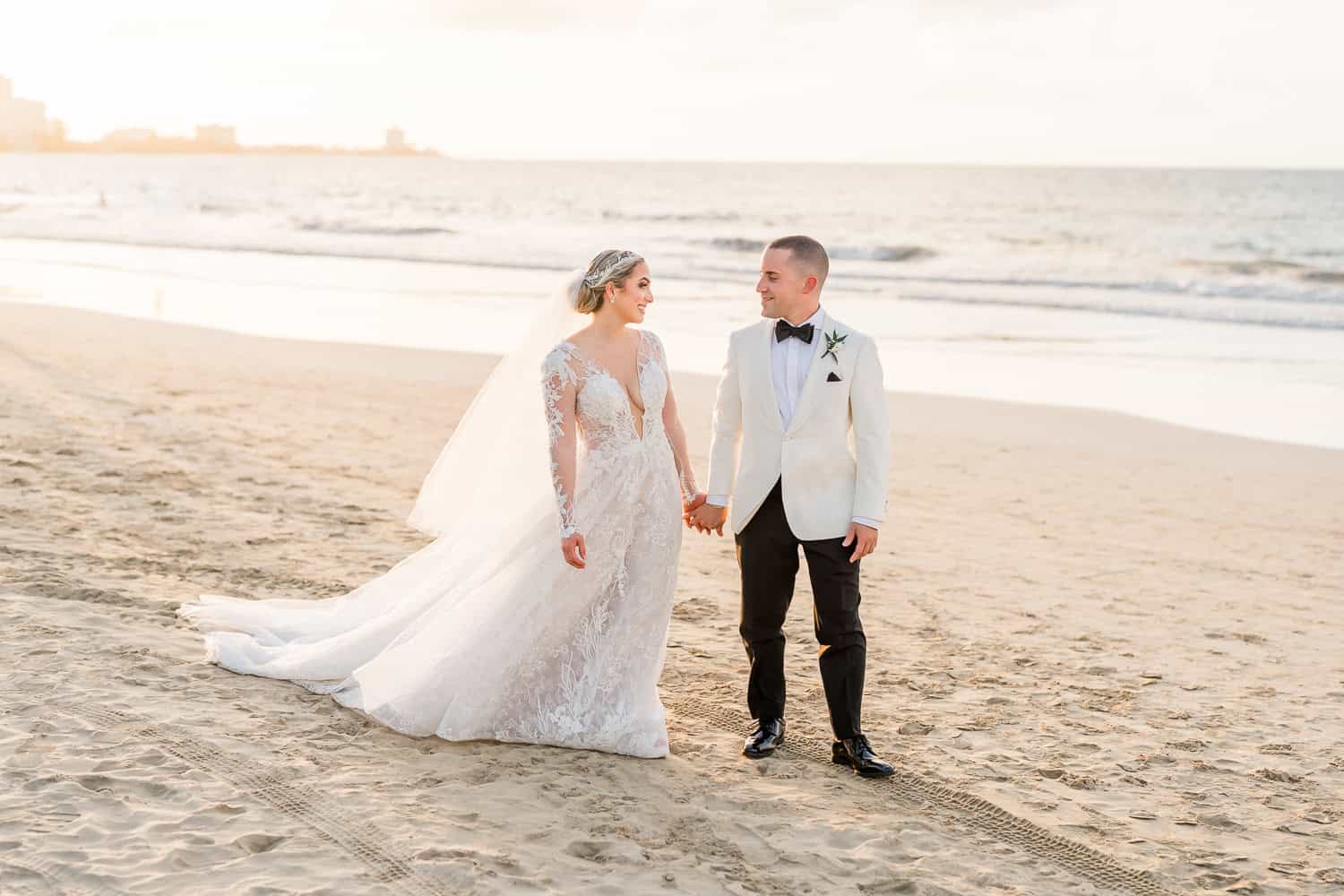 A wedding photographer capturing a couple's special moment on the beach.