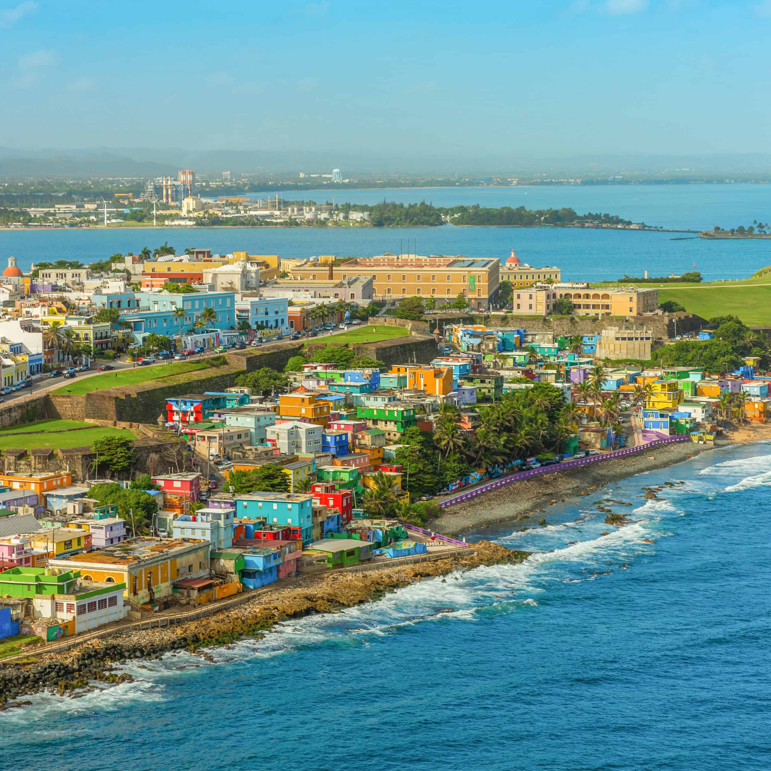 Vibrant, colorful houses line the streets of San Juan, Puerto Rico, showcasing the city's rich architectural heritage.